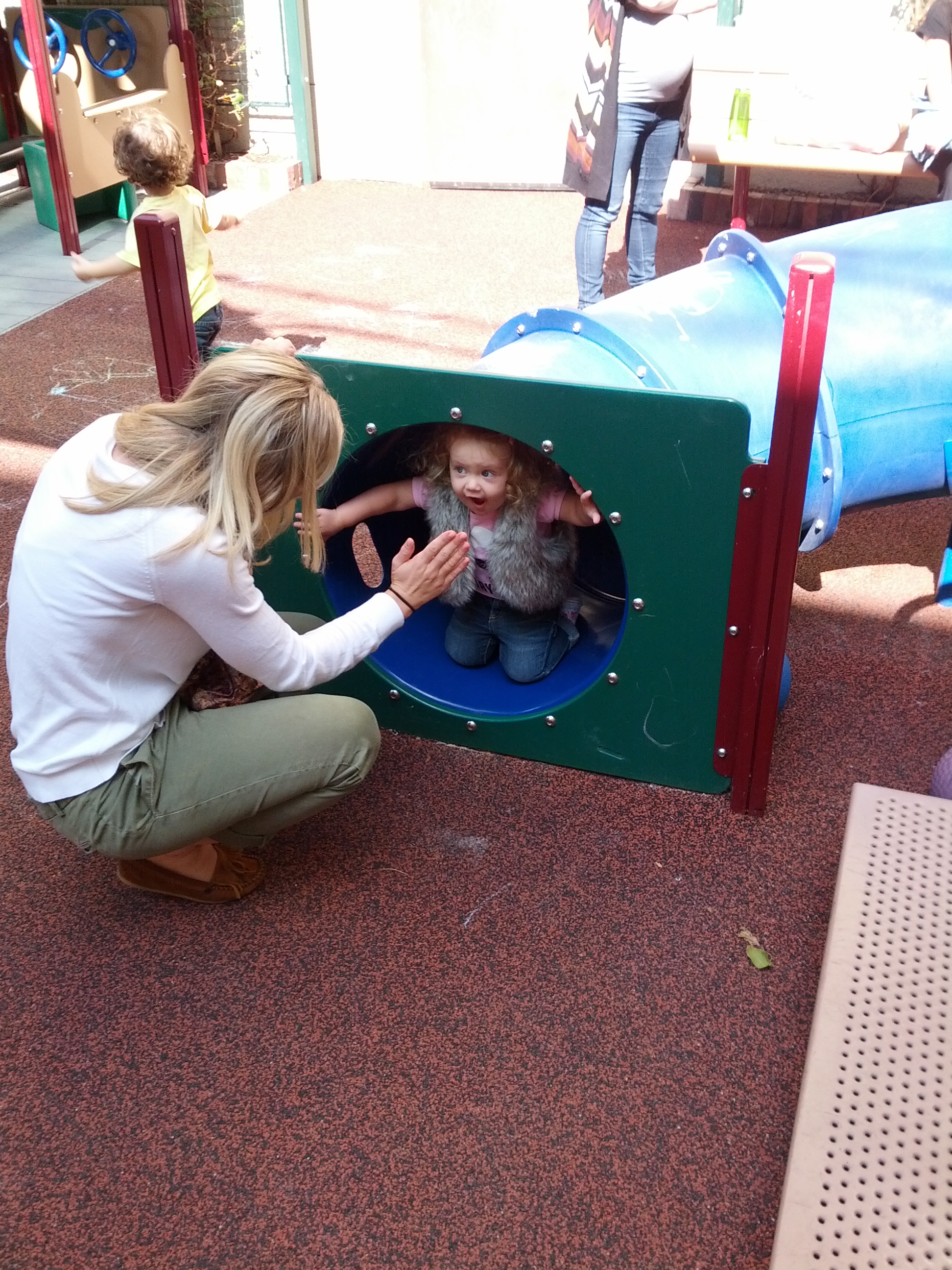 Frankie in a playground tube at preschool